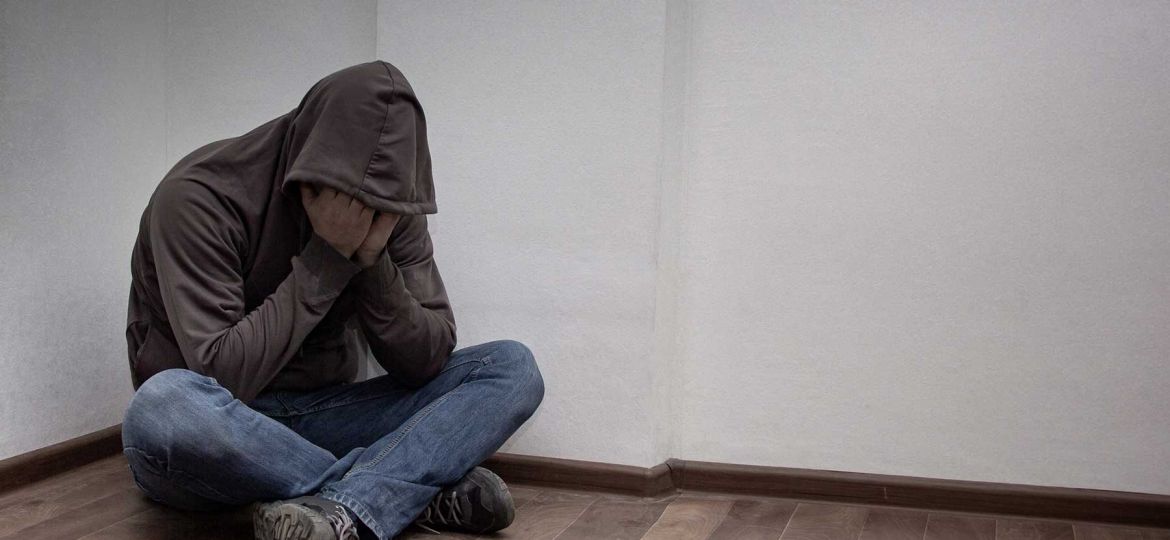 A mad covering his face in sadness.