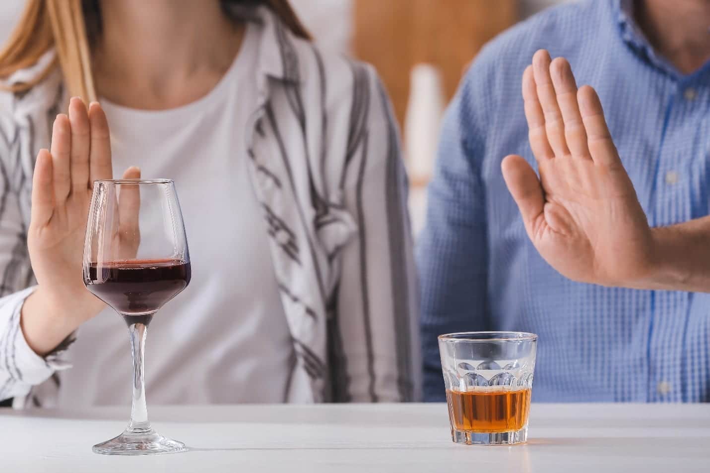 Couple refusing to drink wine and whiskey