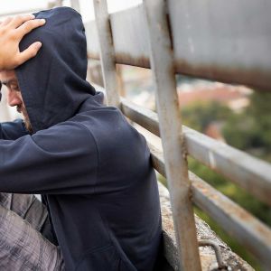 A man sitting and thinking about drug rehab.