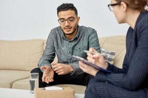 a person talks to a therapist while gesturing