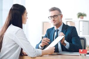 a person with cigna insurance coverage speaks with an admissions counselor who is holding up a piece of paper