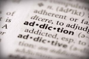 artful image of "addiction" in a dictionary