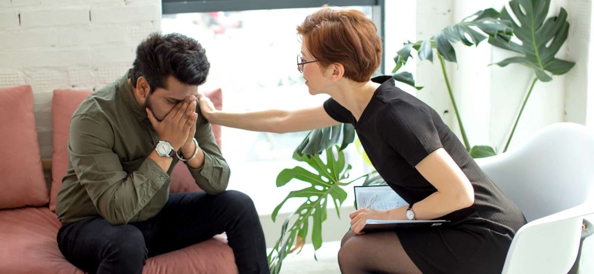 a therapist comforts someone in treatment