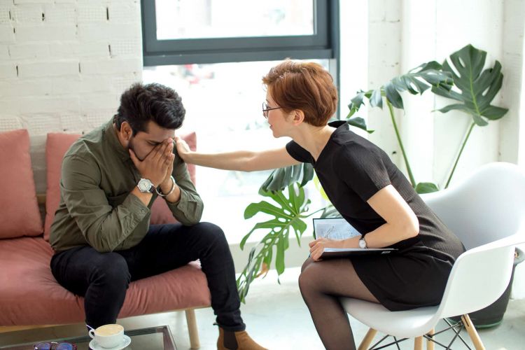 a therapist comforts someone in treatment