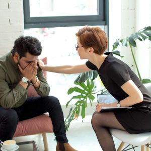 a therapist comforts someone in treatment