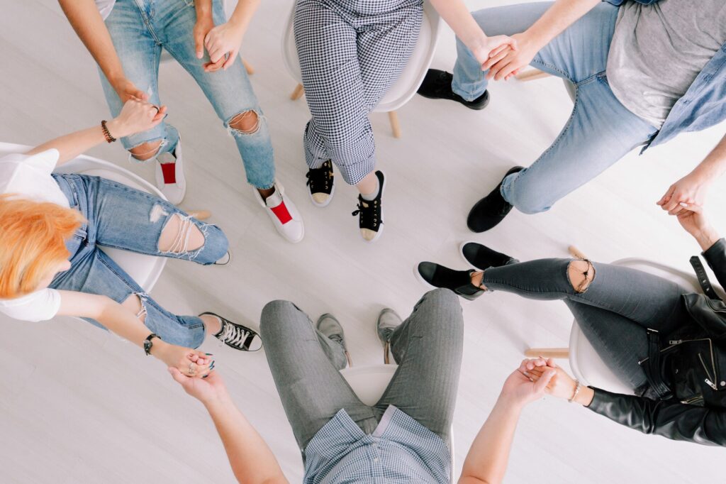a therapy group joins hands in a circle
