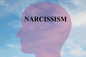 an artful silhouette of a head with the word "narcissism