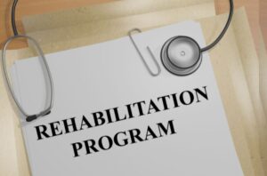 a paper under a stethoscope reading "rehabilitation program"