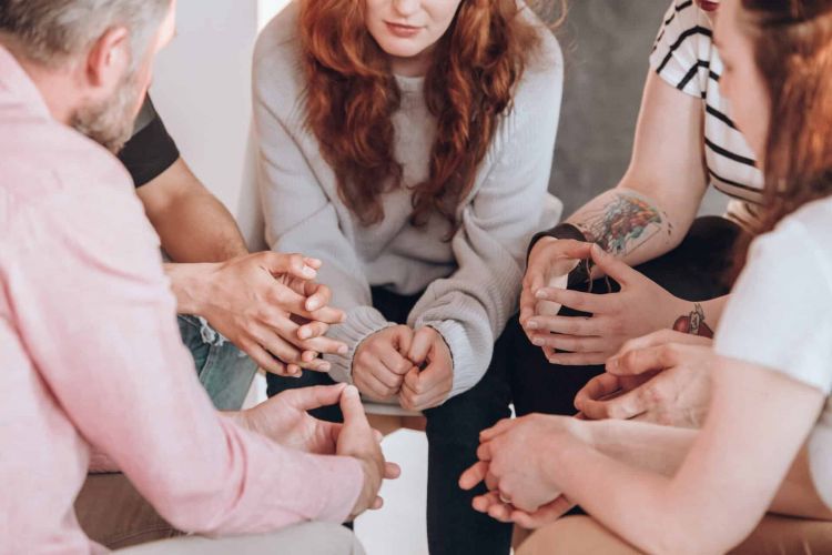 A group of clients in therapy at Apex Rehab.