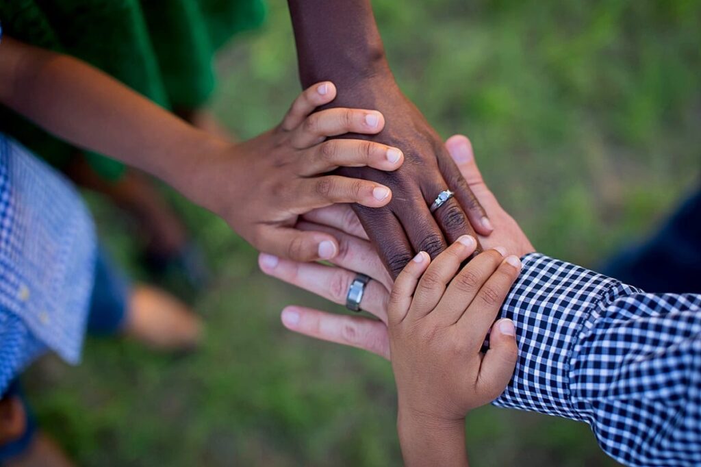 a group of people stack hands