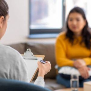 a therapist reads off of a clipboard to a person
