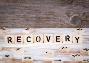 wooden blocks that spell "recovery"
