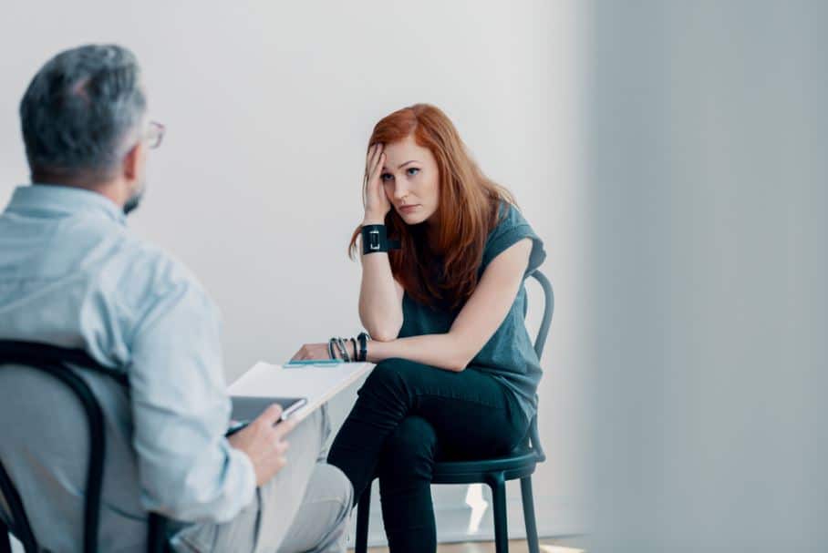 a person looks anxiously at their therapist