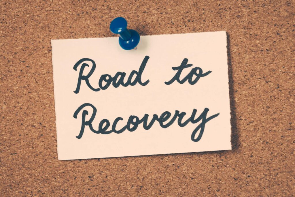 a pinned card on a board reading "road to recovery"