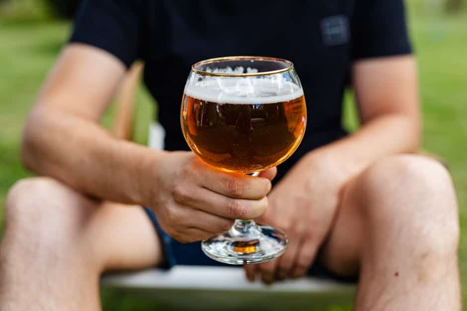 a person holds a beer