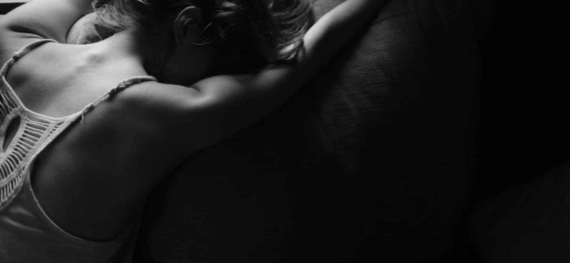 a person leans on a couch dramatically