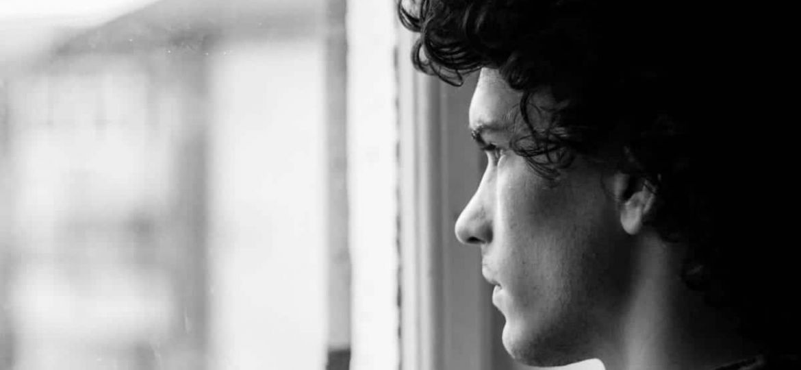 a person looks out a window