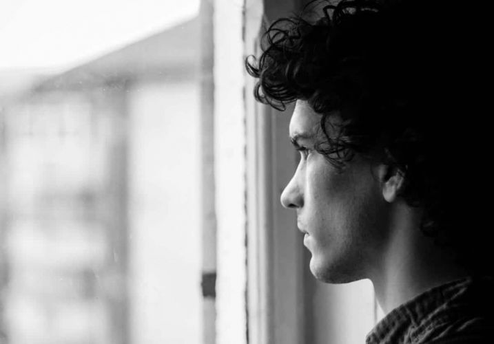 a person looks out a window