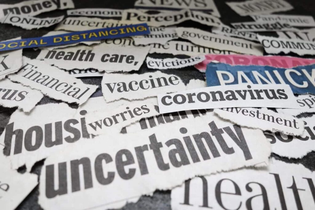 newspaper cutouts of words "money online economy news money uncertain perception struggle pandemic social distancing government health care evictions financial vaccine coronavirus worries uncertainty investment"