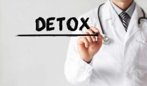 a doctor writes "detox" on a board
