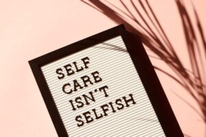 a sign reading "self care isn't selfish"