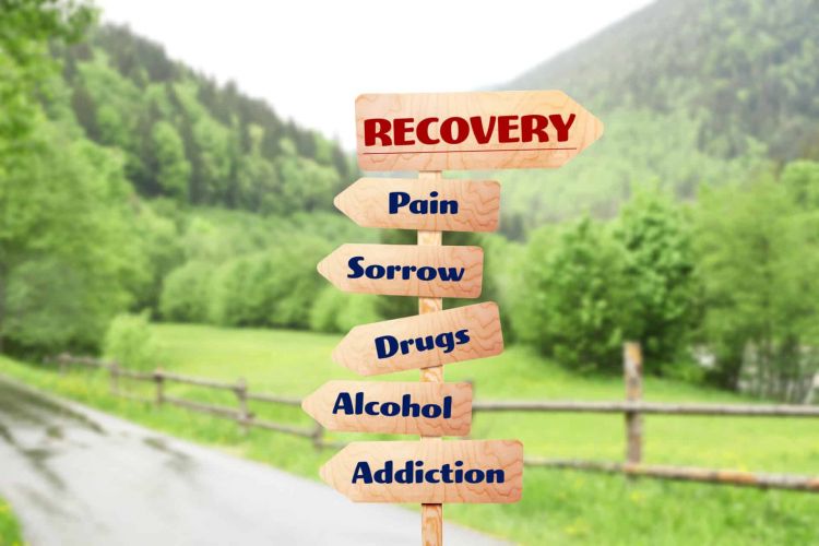 arrow signs that read "recovery" "pain" "sorrow" "drugs' "alcohol" "addiction"