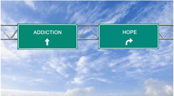 two road signs that read "addiction" and "hope" pointing different directions