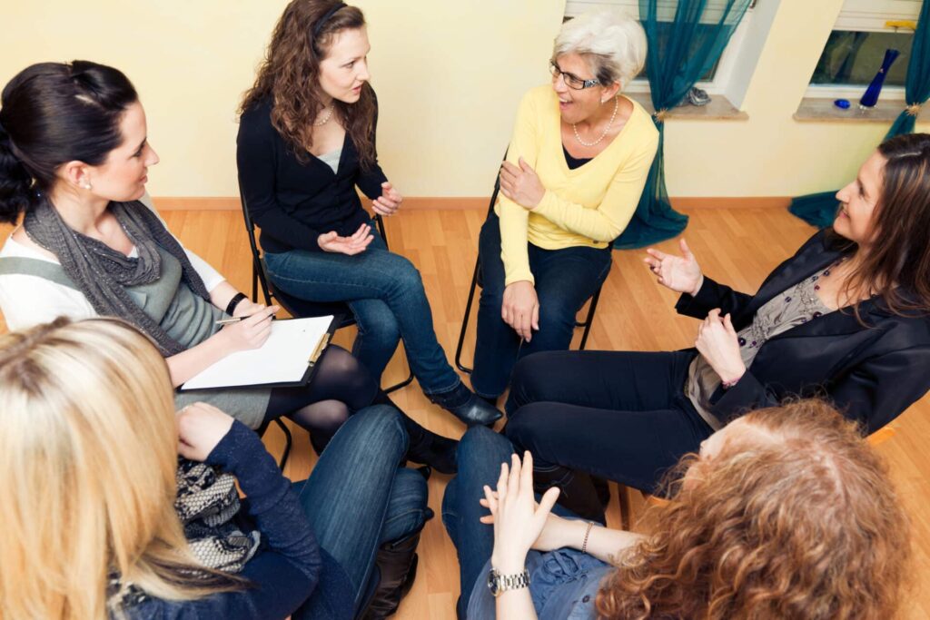 a group smiles at a therapist