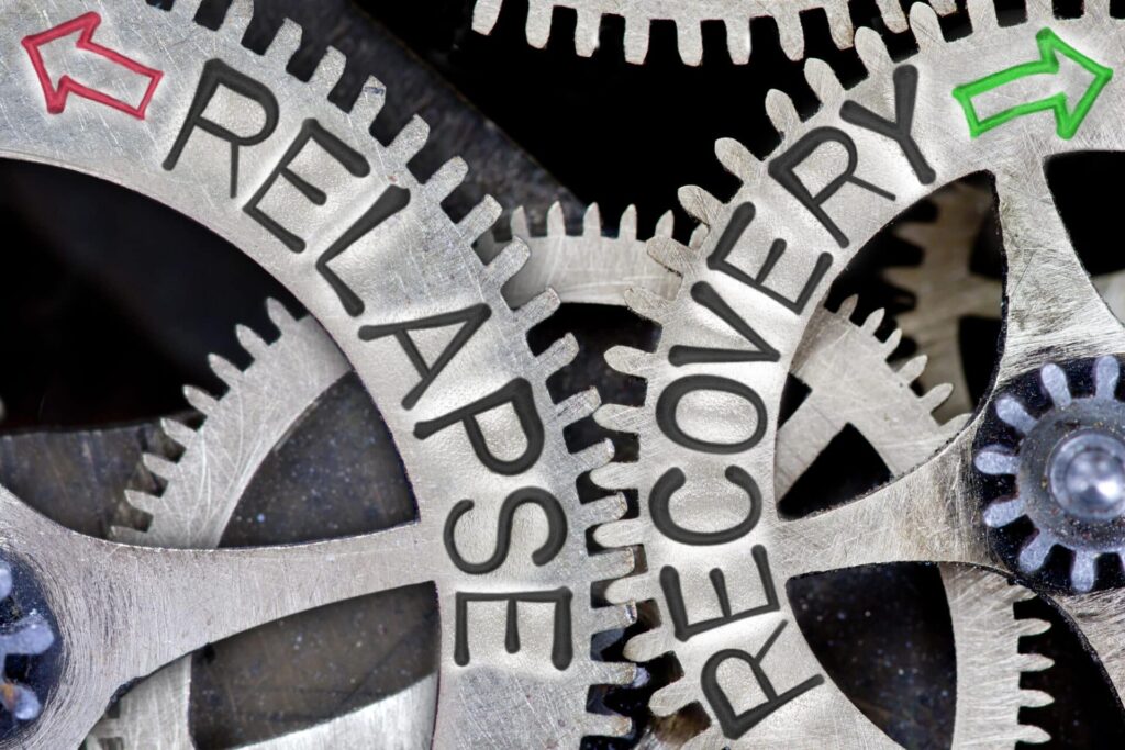 gears in opposite directions that read "relapse" and "recovery'