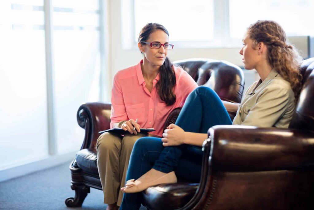 a therapist holds a person as they talk