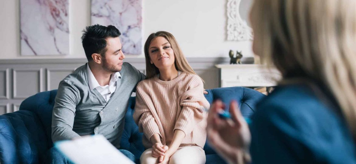a couple looks hopefully toward a therapist