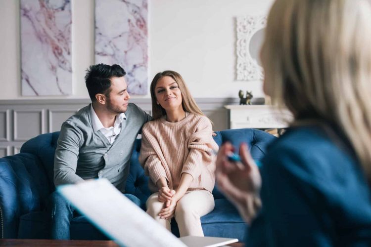 a couple looks hopefully toward a therapist