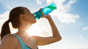 a person drinks water in the sun
