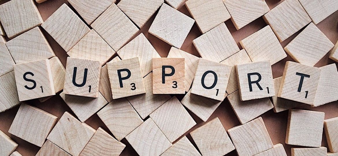 scrabble tiles spelling "support"
