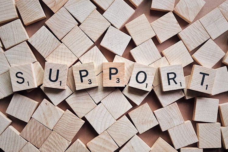 scrabble tiles spelling "support"