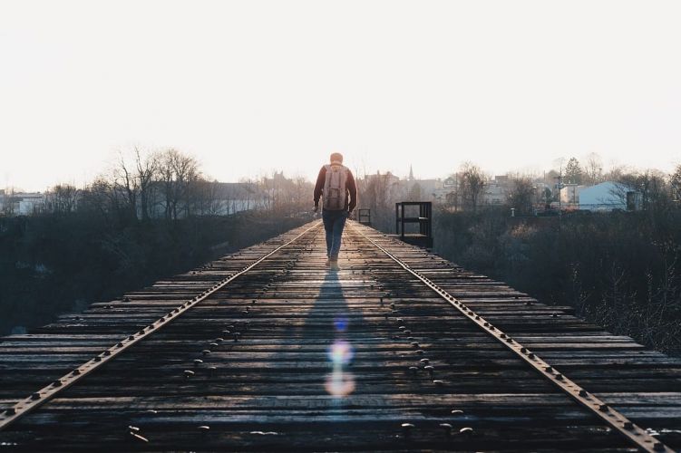a person walks along a boardwalk