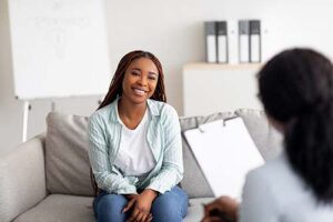 A woman suffering polysubstance abuse talks to therapist