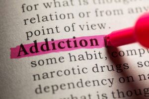 Addiction definition, symbolizing the question, "Is addiction a disease?"
