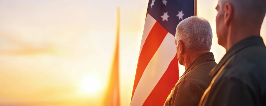 Flagraising ceremony on Veterans Day, with veterans standing in salute as the flag ascends