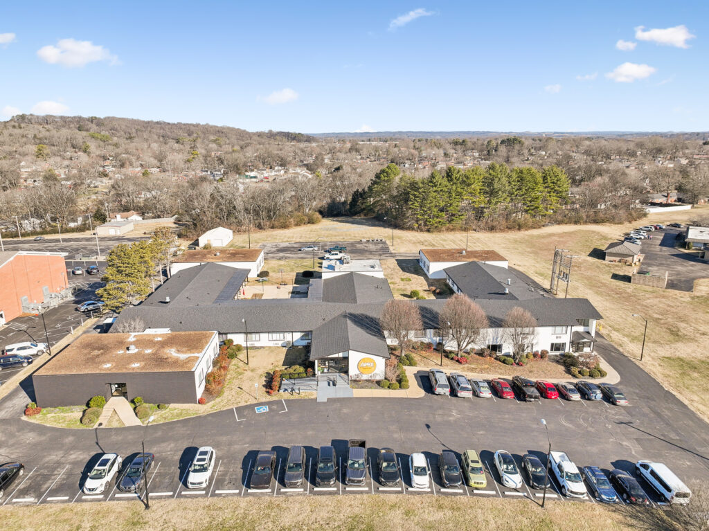 Ariel drone photograph of the entire grounds of apex recovery, showing the outdoor areas and the main facility building