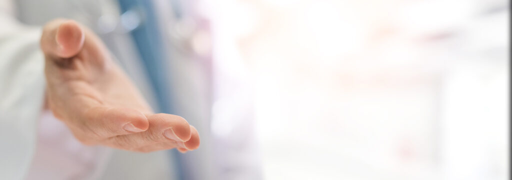 Hand of physician in hospital offering support service for patient.