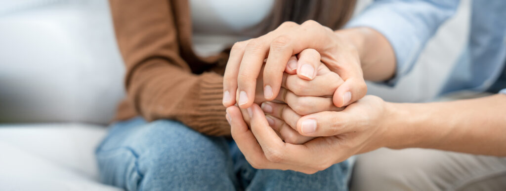 Couple hold hands while they contemplate the need for rehab