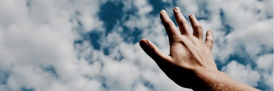 young girl covering her eyes facing the sky as she struggles with mental health issues