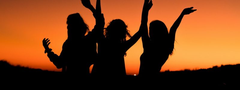 Silhouette of women celebrating recovery.